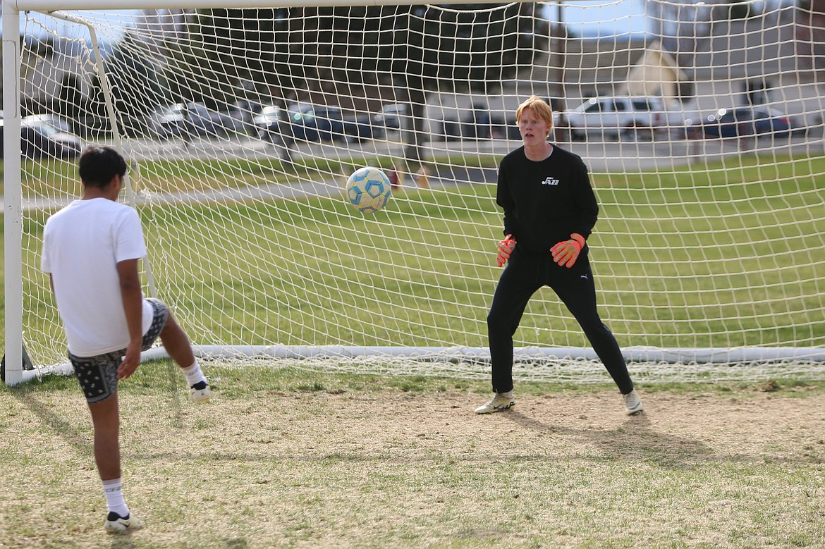 Othello senior Aksel Jebsen, right, practices blocking shots during a March 25 practice. Jebsen stands at six-foot-eight, making him an obstacle for opposing teams on the attack.