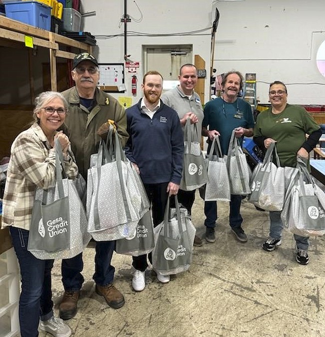 Gesa Credit Union's team from its Post Falls branch recently volunteered with Newby-ginnings of North Idaho, a Post Falls nonprofit dedicated to providing necessities and essential household items for veterans and active military families. The team spent the day stocking shelves with 15 grocery bags filled with pantry items. Pictured, from left: Theresa Hart and Darrell Mayer, Newby-ginnings; Nicholas Hunter and Matthew Leslie, Post Falls Gesa; and Timothy Wilhite and Terry Wiggs, Newby-ginnings.