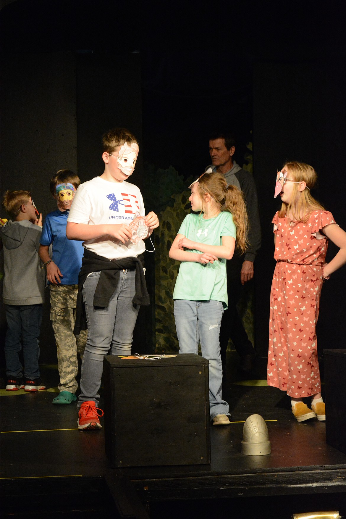 Wearing masks, third-graders Gunnar Visintainer, Emily Hammeren and Piper Usher act out "The House that Jack Built."