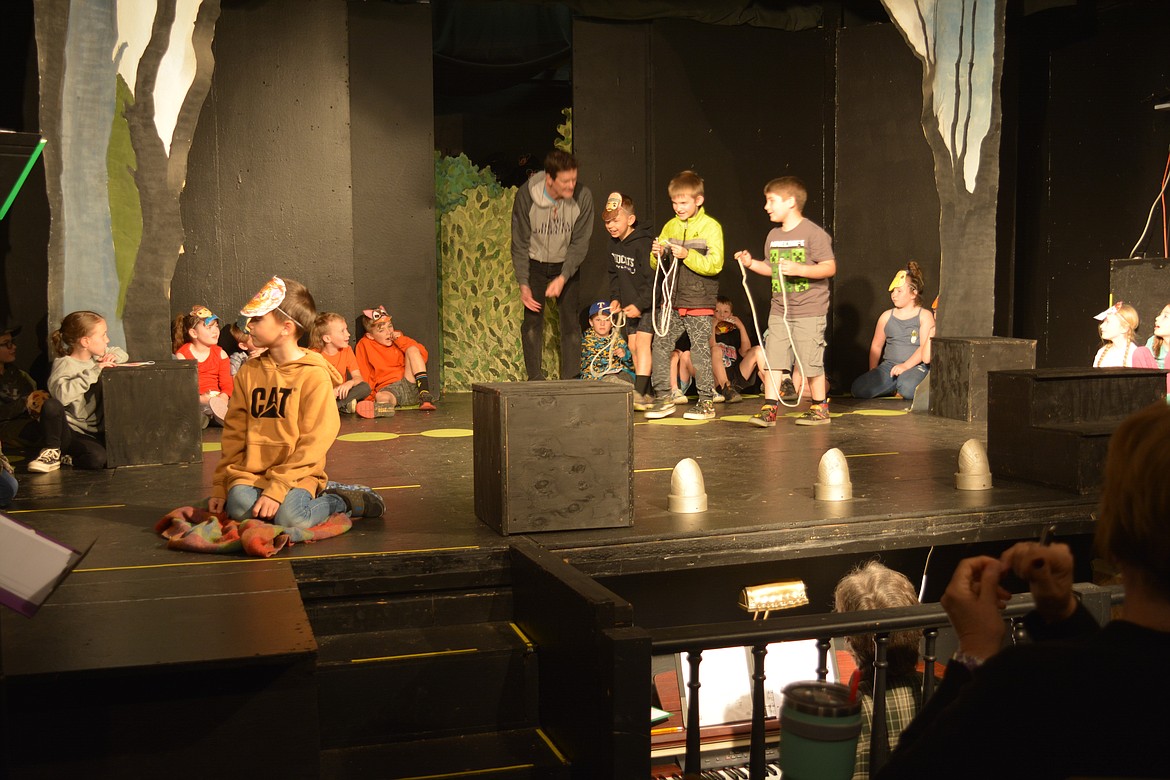 Oakley Dumont plays the lion in a play as Paul Roberts directs Westin Mann, Asher Cramer and Sam Wendel on how to "hunt" the lion.