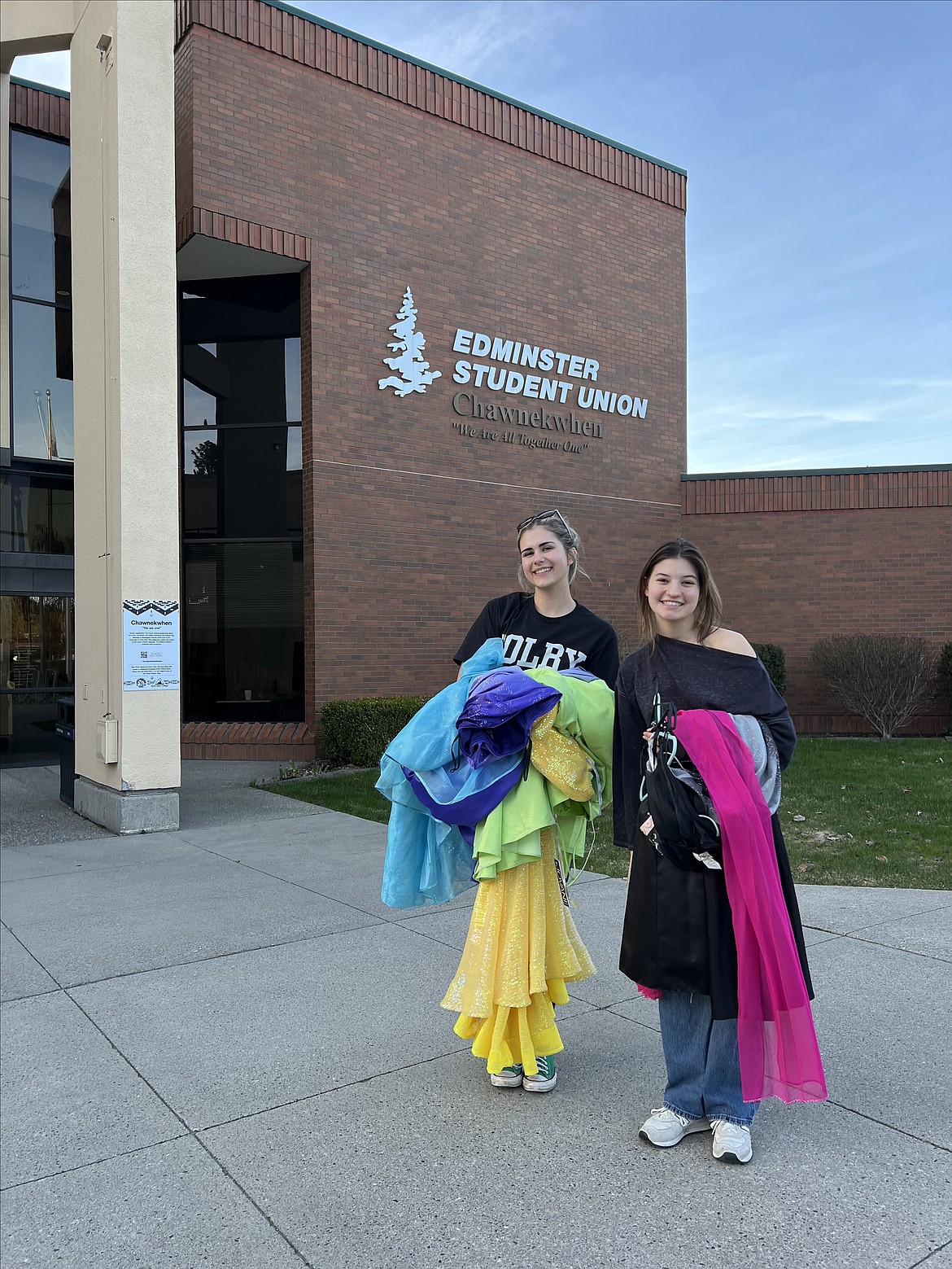 Club leaders Abby Fitzgerald and Ari Begalman of the Ant’oqmi’wes Club bring dresses to a pop-up dress drive at North Idaho College.