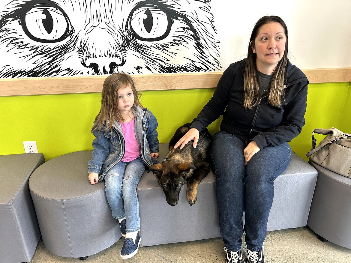 Melyssa Moss and daughter Everly wait with Leo in the lobby of Companions Animal Center on Wednesday.