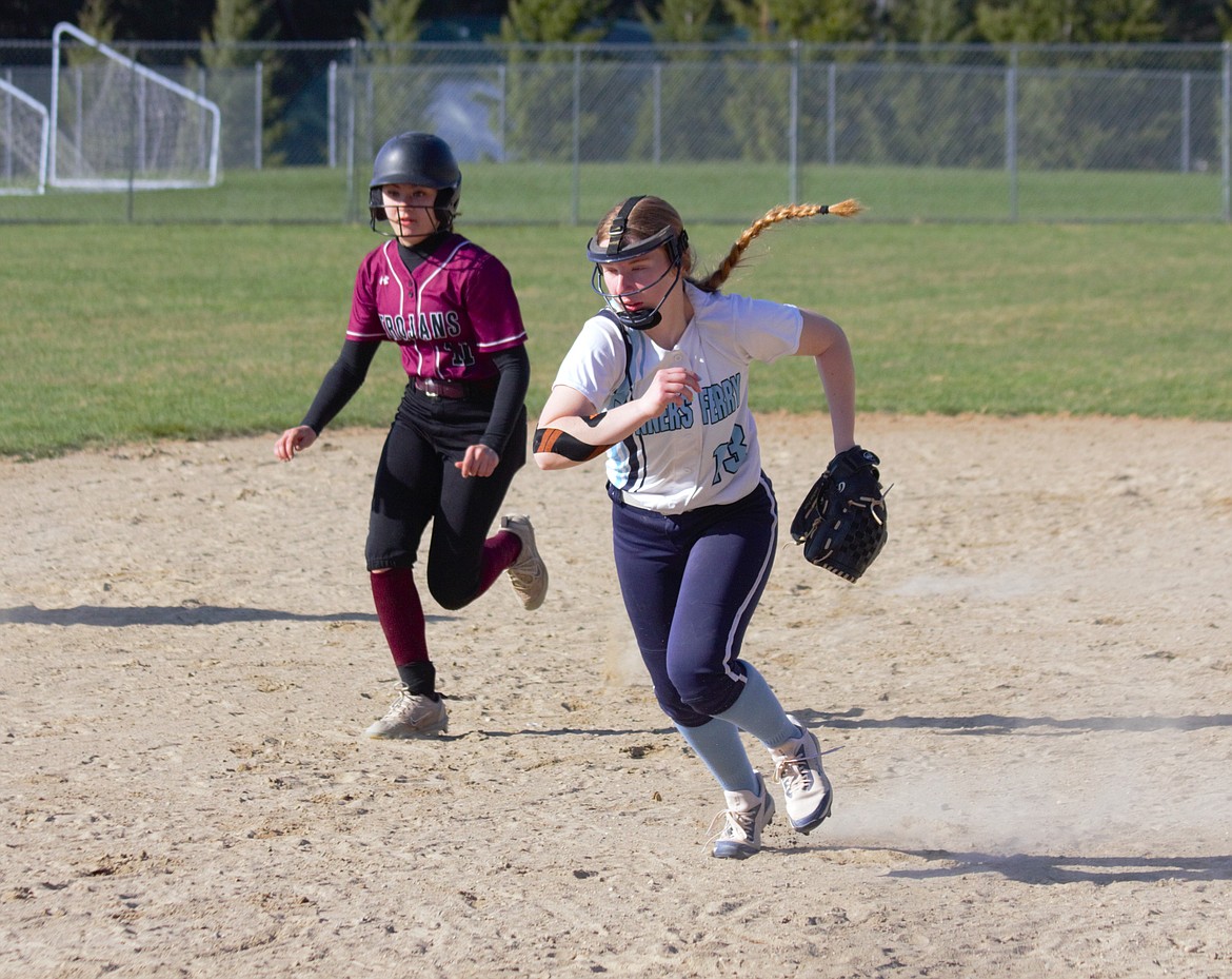 Third base player Jaydin Falck gets runner out at third by foot race.