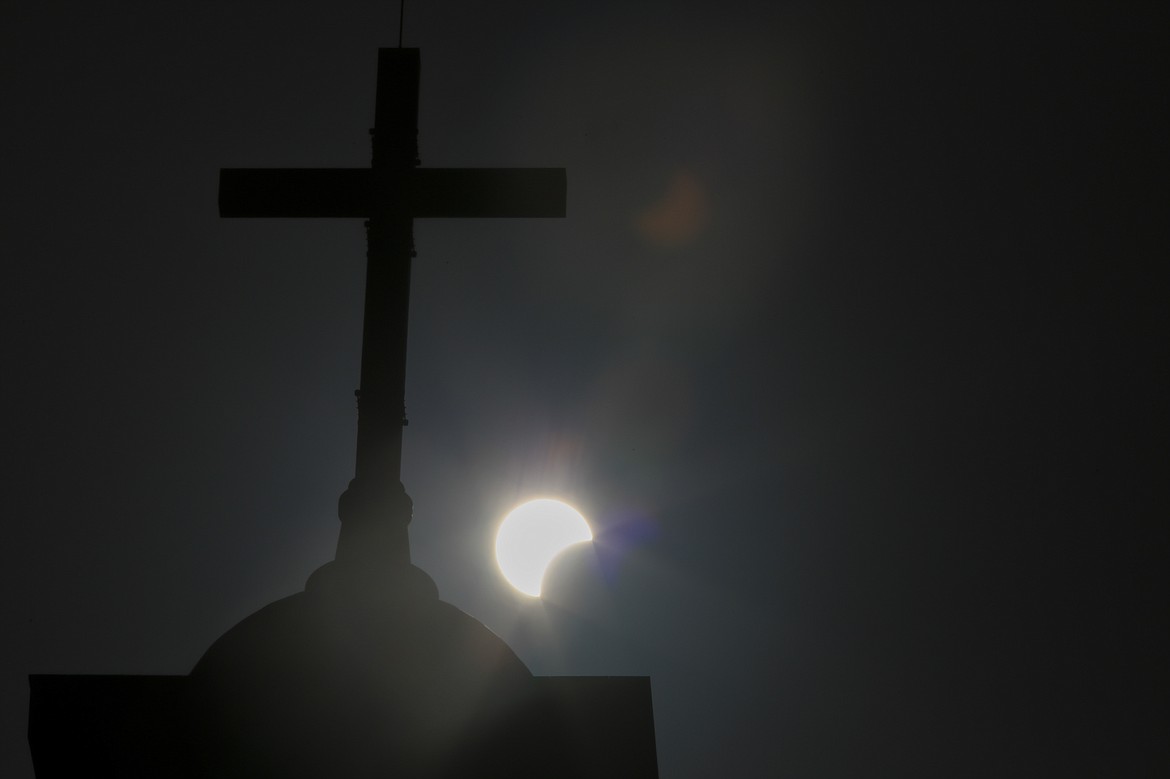 A partial solar eclipse is seen behind a cross on the steeple of the St. George church, in downtown Beirut, Lebanon on June 21, 2020. Throughout history, solar eclipses have had profound impact on adherents of various religions around the world. They were viewed as messages from God or spiritual forces, inducing emotions ranging from dread to wonder.