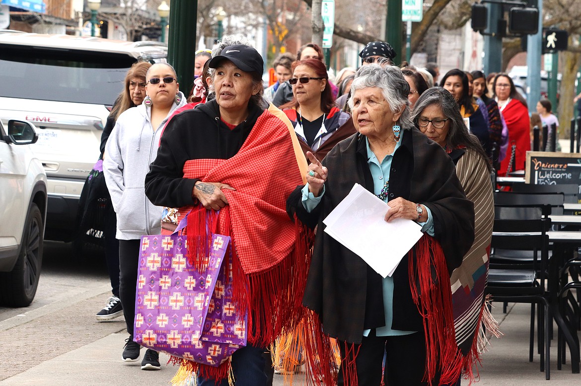 Dixie Stensgar, left, and Mary Jane Miles take part in the "Shawls in Solidarity" march against racism in downtown Coeur d'Alene and Thursday.