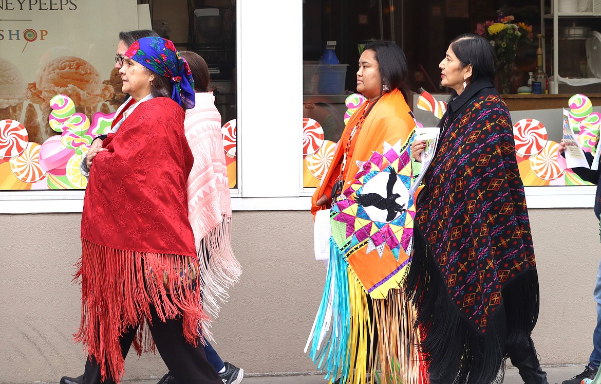Walkers, including Diosa Bahe, with orange shawl, join "Shawls in Solidarity" in downtown Coeur d'Alene on Thursday.