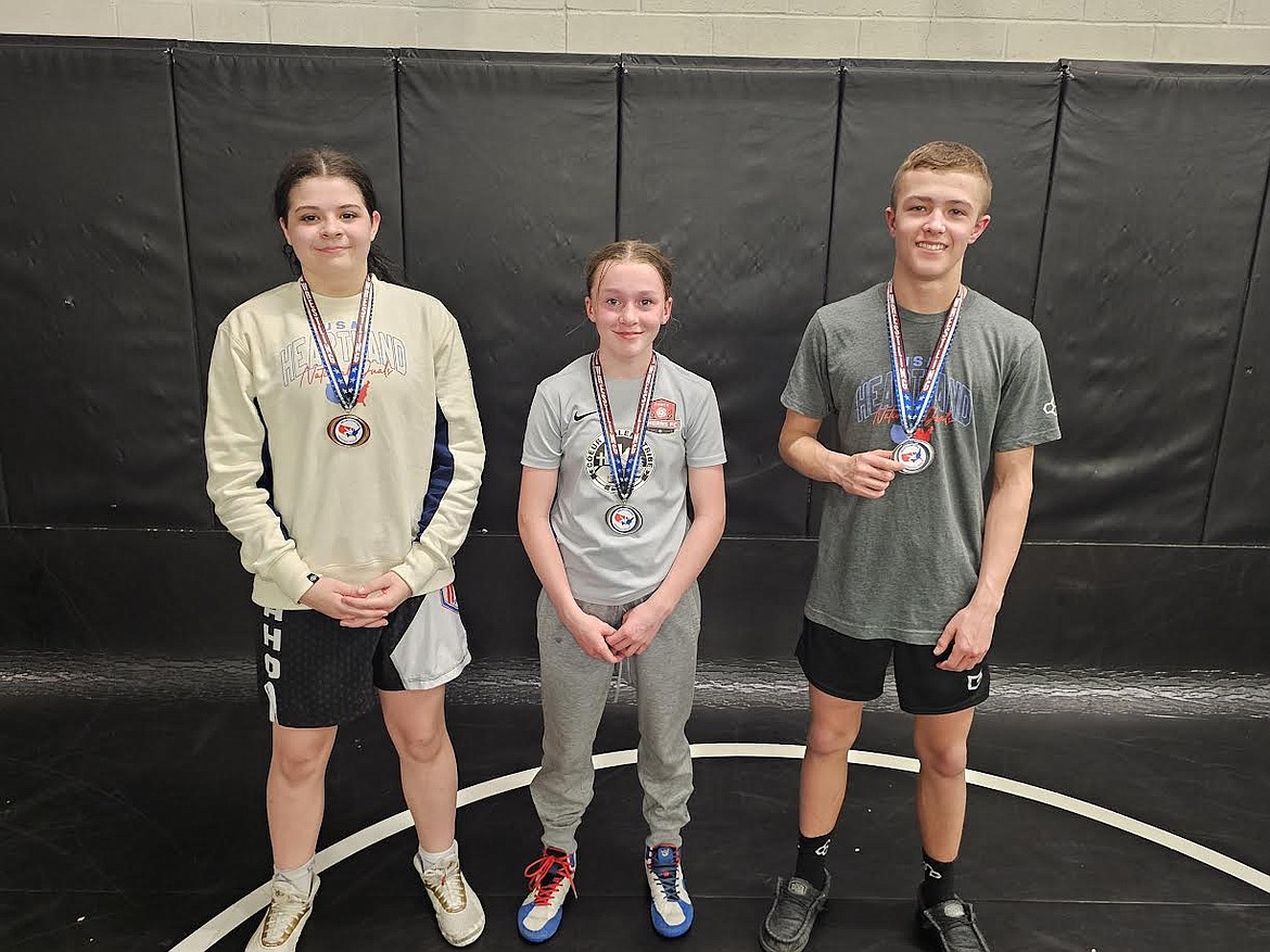 Courtesy photo
Three Team Real Life wrestlers earned their spot on the USA Idaho Wrestling team recently at the Heartland Duals in Iowa. Kahli Brown, left, and Kenzie Dolan participated on the girls team which took eighth place in the Diamond bracket. Ryker Allen, right, participated on the middle school team which took second in the Gold bracket.