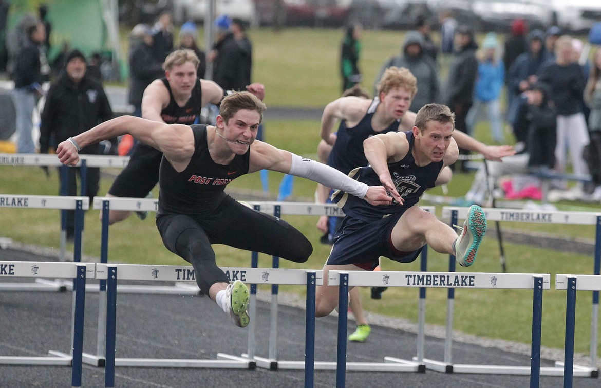 JASON ELLIOTT/Press
Post Falls senior Taycen Genatone and Timberlake senior Caius Tebbe leap over another hurdle during the boys 110-meter hurdle race at the Kootenai County Challenge on Friday at Timberlake High. Genatone won the race in 15.25 seconds, followed by Tebbe in 15.50.