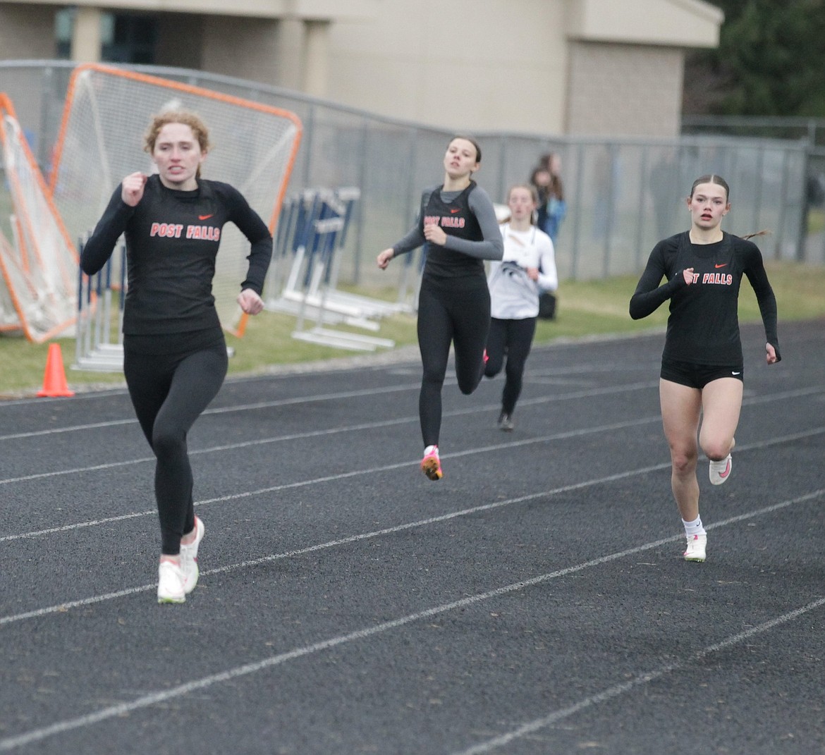 JASON ELLIOTT/Press
Post Falls senior Kinlee McLean takes the lead on teammate Reagan Hutchinson in the last few meters of the girls 400-meter dash at the Kootenai County Challenge on Friday at Timberlake High.