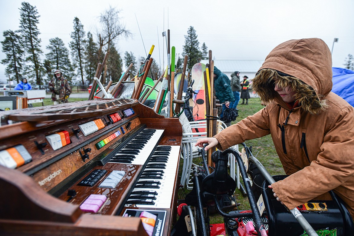Carson Jilek checks out a Kimball Temptation electric organ at the 58th annual Creston Auction and Country Fair on Saturday, April 6. The event is the largest fundraiser for the Creston Fire Department and has been held since 1966. (Casey Kreider/Daily Inter Lake)