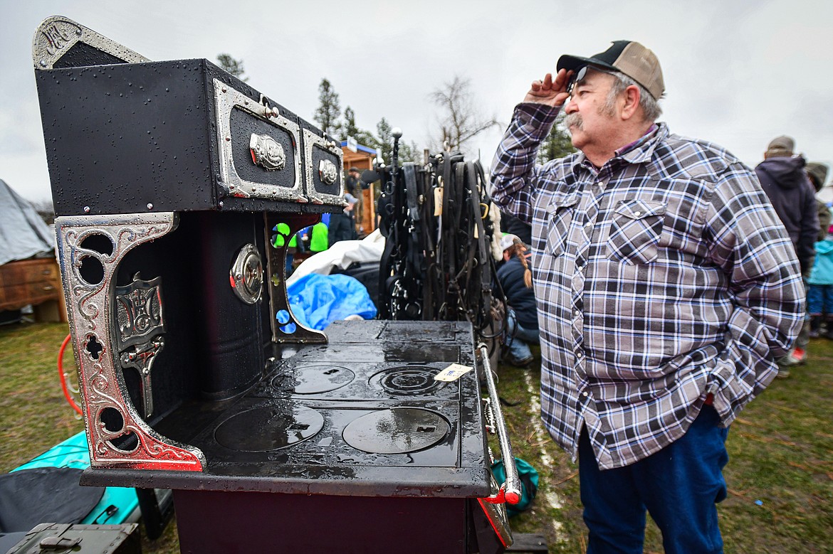 A visitor looks over a Monarch wood stove up for sale at the 58th annual Creston Auction and Country Fair on Saturday, April 6. The event is the largest fundraiser for the Creston Fire Department and has been held since 1966. (Casey Kreider/Daily Inter Lake)