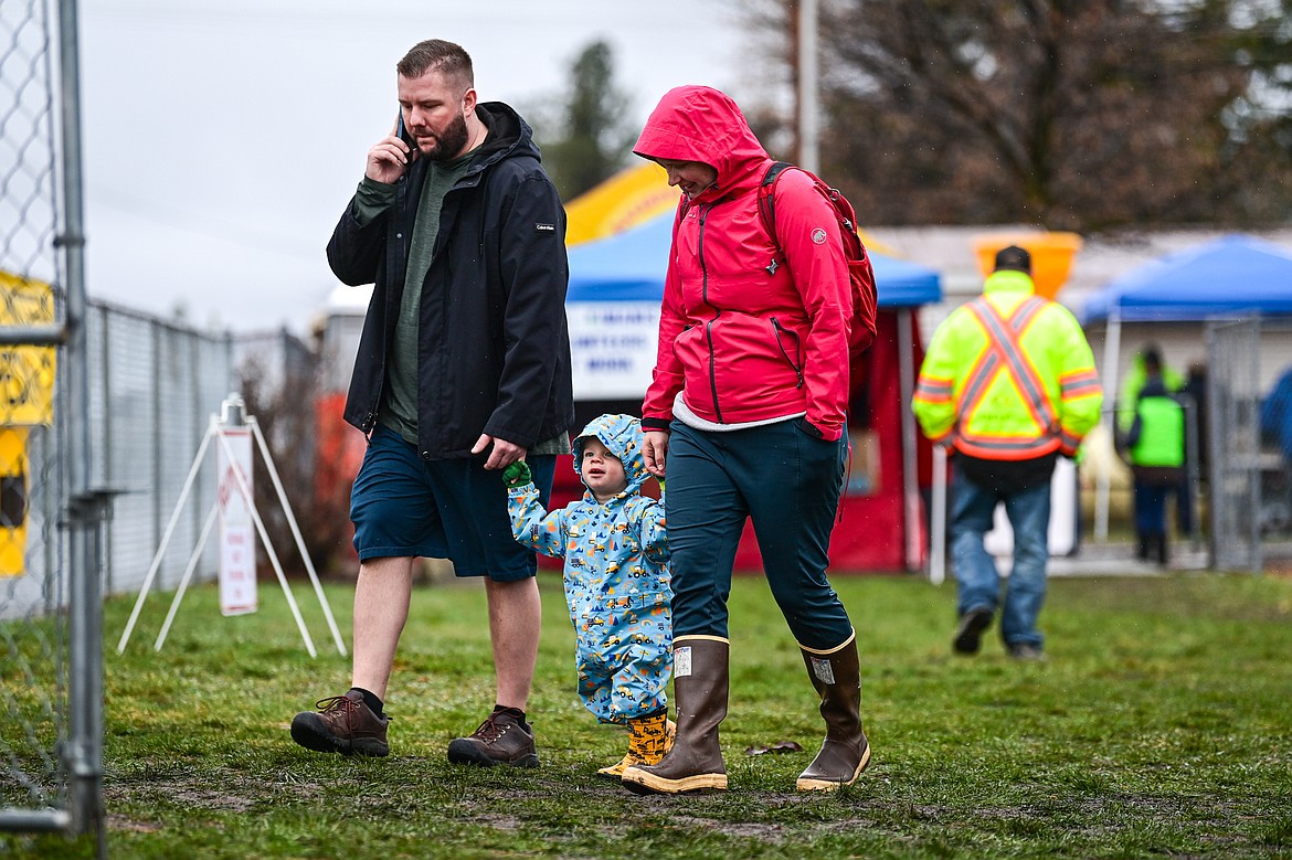 A young auction-goer stays dry from the rain at the 58th annual Creston Auction and Country Fair on Saturday, April 6. The event is the largest fundraiser for the Creston Fire Department and has been held since 1966. (Casey Kreider/Daily Inter Lake)
