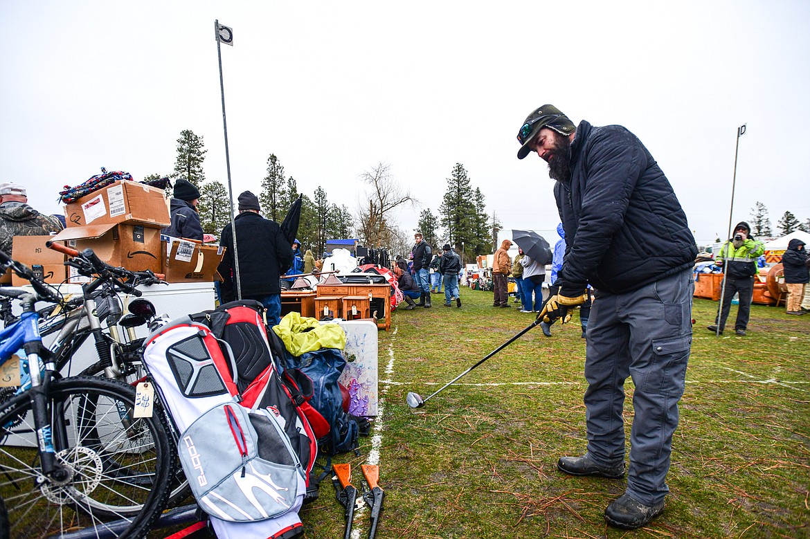 Zach Husted tries out a driver from a set of golf clubs at the 58th annual Creston Auction and Country Fair on Saturday, April 6. The event is the largest fundraiser for the Creston Fire Department and has been held since 1966. (Casey Kreider/Daily Inter Lake)
