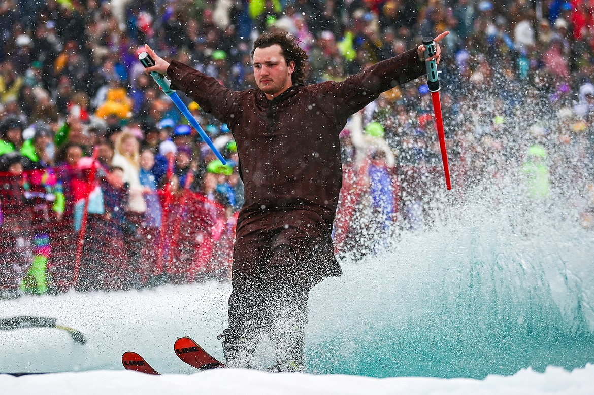 Participants ski or snowboard across the water during the pond skim at Whitefish Mountain Resort on Saturday, April 6. (Casey Kreider/Daily Inter Lake)