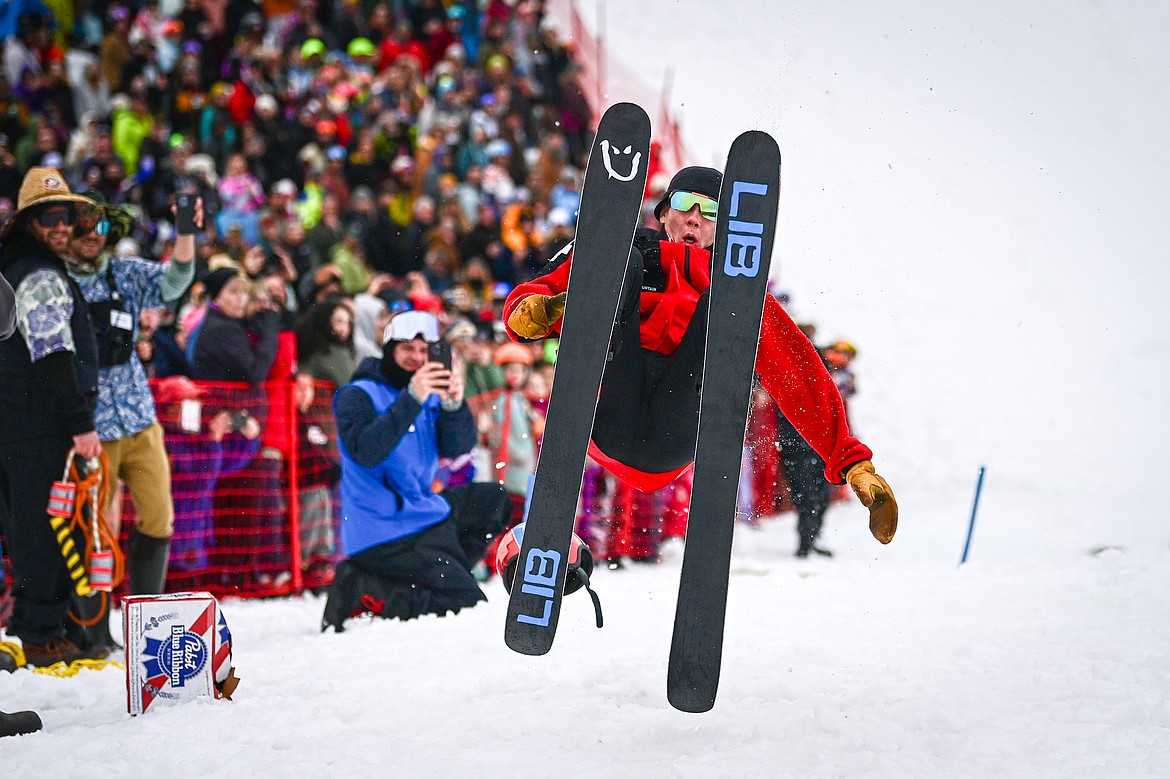 Anders Soyland lands a front flip out of the pool after a successful trip across the water at the pond skim at Whitefish Mountain Resort on Saturday, April 6. (Casey Kreider/Daily Inter Lake)