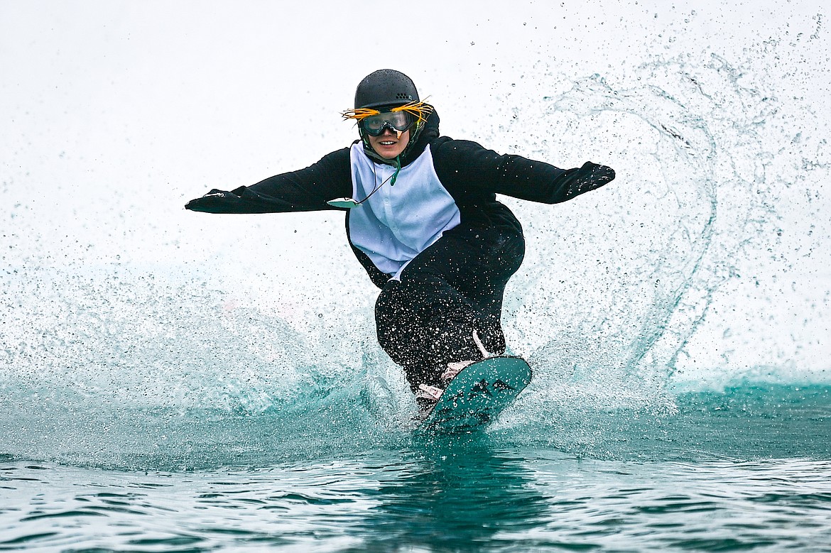 Participants ski or snowboard across the water during the pond skim at Whitefish Mountain Resort on Saturday, April 6. (Casey Kreider/Daily Inter Lake)