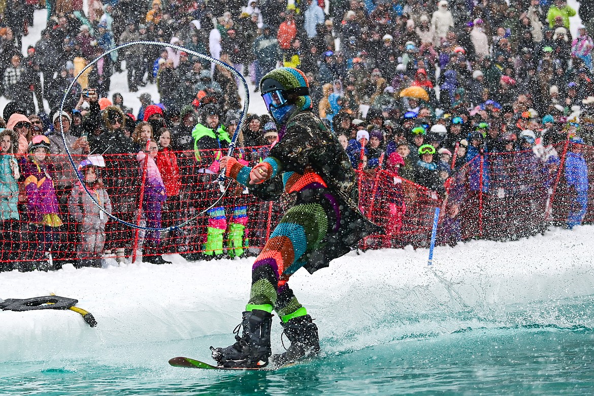 Participants ski or snowboard across the water during the pond skim at Whitefish Mountain Resort on Saturday, April 6. (Casey Kreider/Daily Inter Lake)