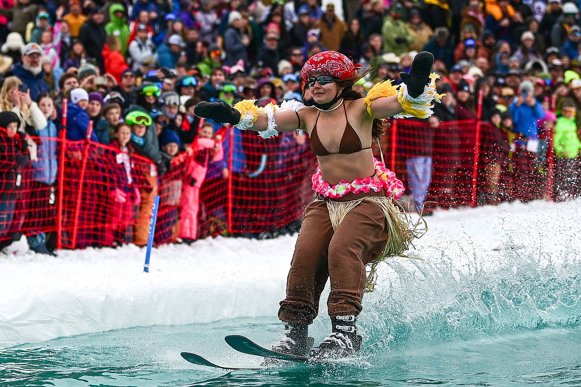 Participants ski or snowboard across the water during the pond skim at Whitefish Mountain Resort on Saturday, April 6. (Casey Kreider/Daily Inter Lake)