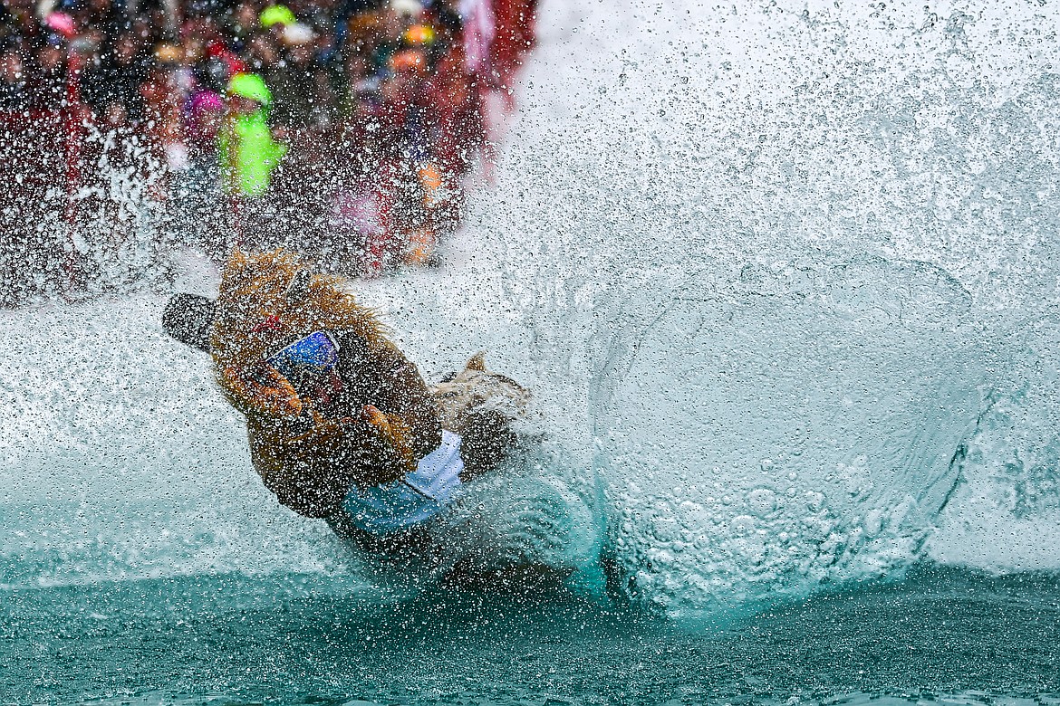 Participants ski or snowboard across the water during the pond skim at Whitefish Mountain Resort on Saturday, April 6. (Casey Kreider/Daily Inter Lake)