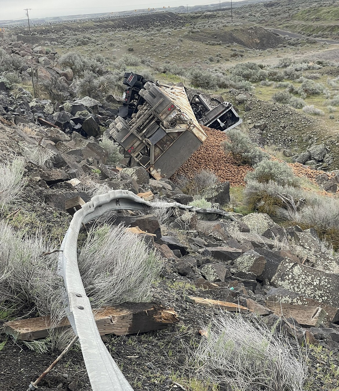 A potato truck rolled and caught fire on SR 262 Friday morning, sending its driver to the hospital and closing the highway for more than eight hours.