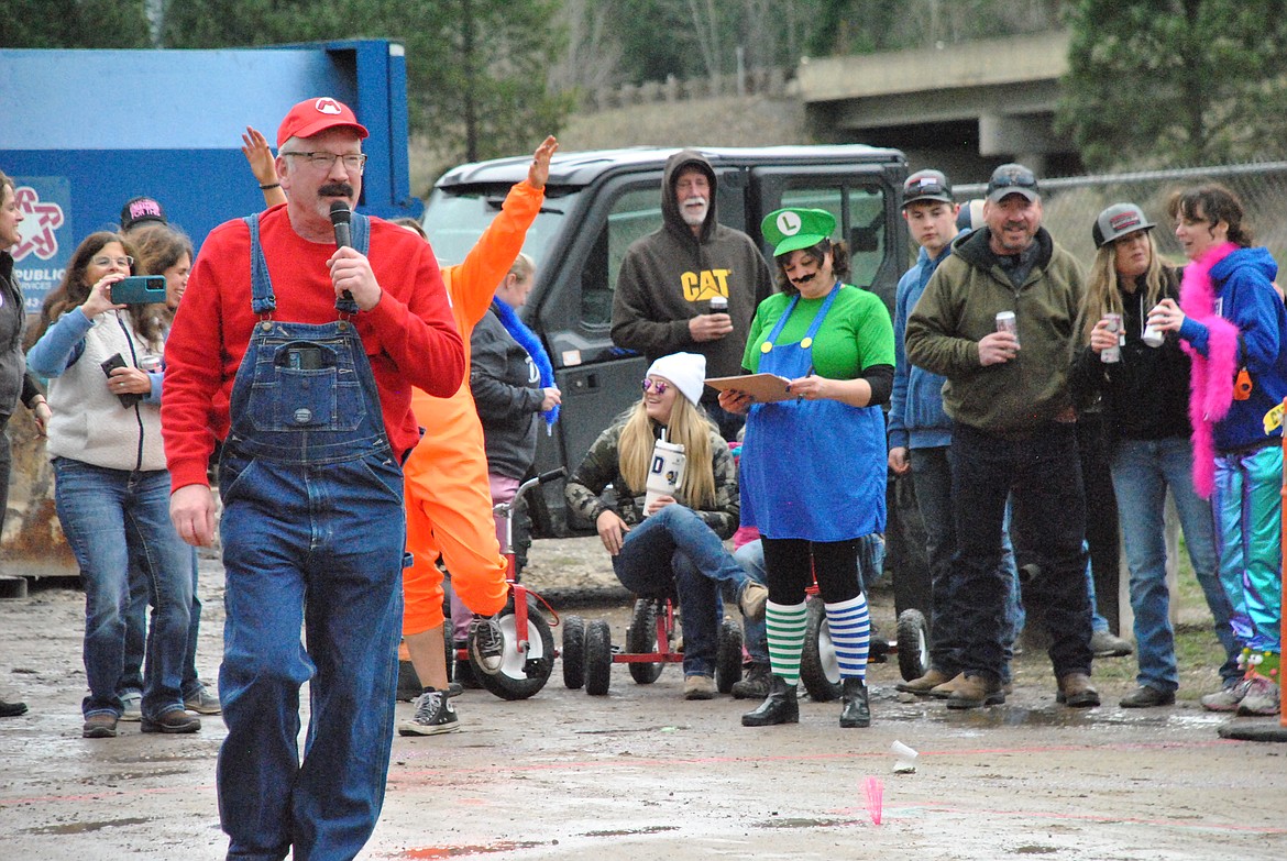 One last ride. Concluding 21 years of trike racing at the Talking Bird International Speedway - the dirt road behind the bar. It was only fitting that Mario, aka, Kenny Jasper would officiate the final mud-flinging races with the help of his assistant, Luigi, Janet Park-Burnham. (Mineral Independent/Amy Quinlivan)