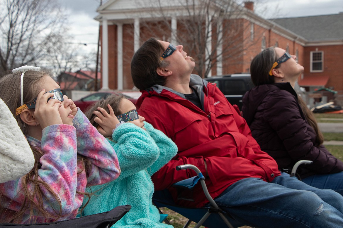 Spectators look at the solar eclipse in Kalispell on April 8, 2024, through an event hosted by the Flathead County Library and the Hockaday Museum of Art. (Kate Heston/Daily Inter Lake)