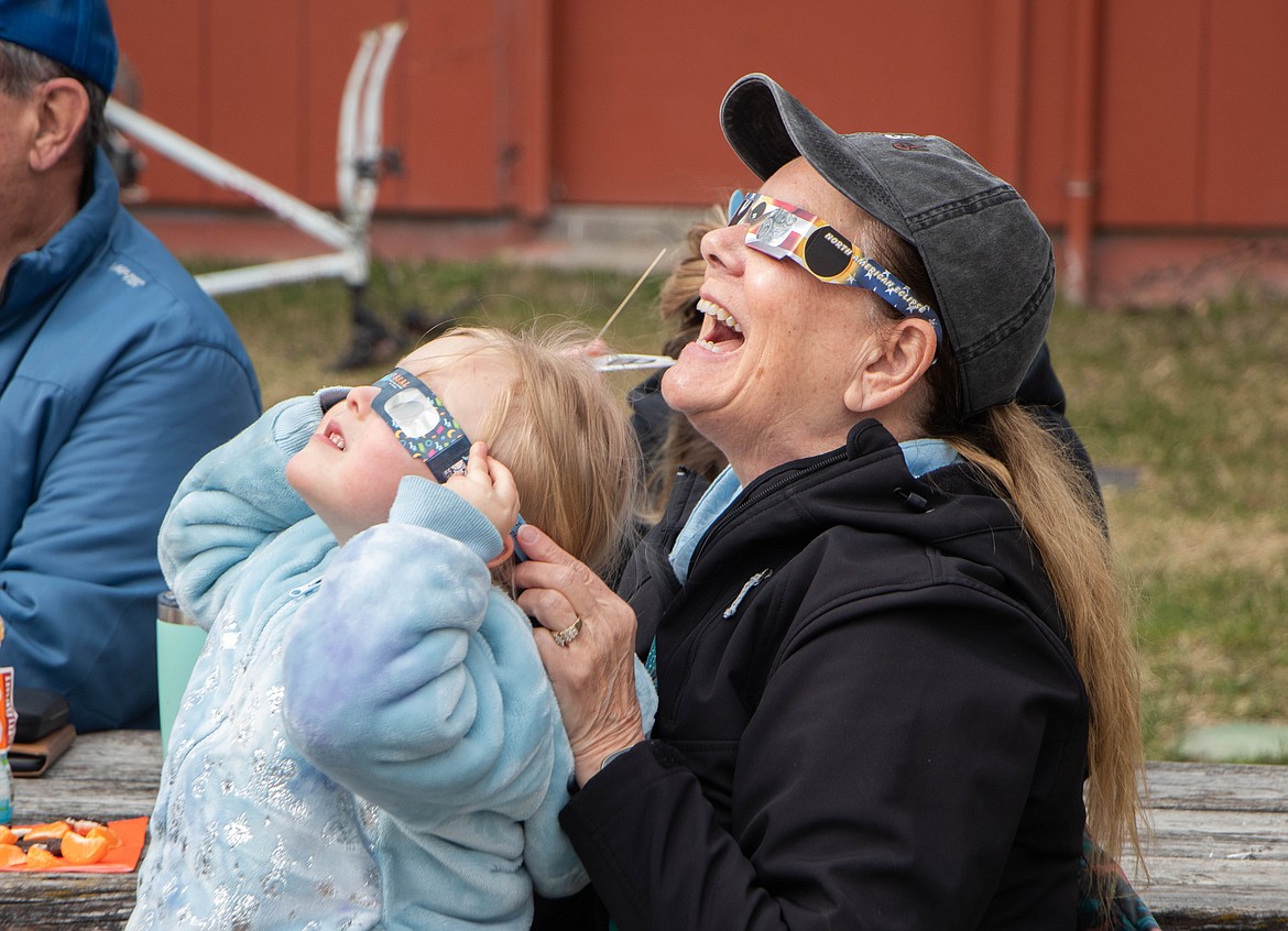 Spectators look at the solar eclipse in Kalispell on April 8, 2024, through an event hosted by the Flathead County Library and the Hockaday Museum of Art. (Kate Heston/Daily Inter Lake)