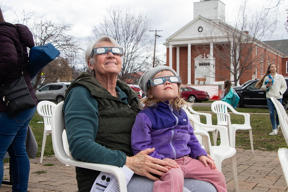 Spectators look at the solar eclipse in Kalispell on April 8, 2024, through an event hosted by the Flathead County Library and the Hockaday Museum of Art. (Kate Heston/Daily Inter Lake)