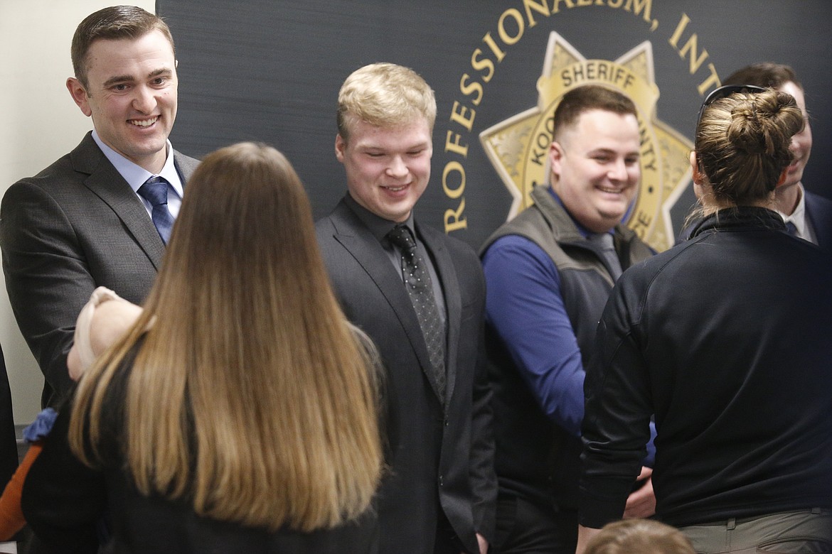 Jake Best, Kyle Hunzaker and Robert Cranfill shake hands with fellow law enforcement personnel after being sworn in as deputies with the Kootenai County Sheriff’s Office.