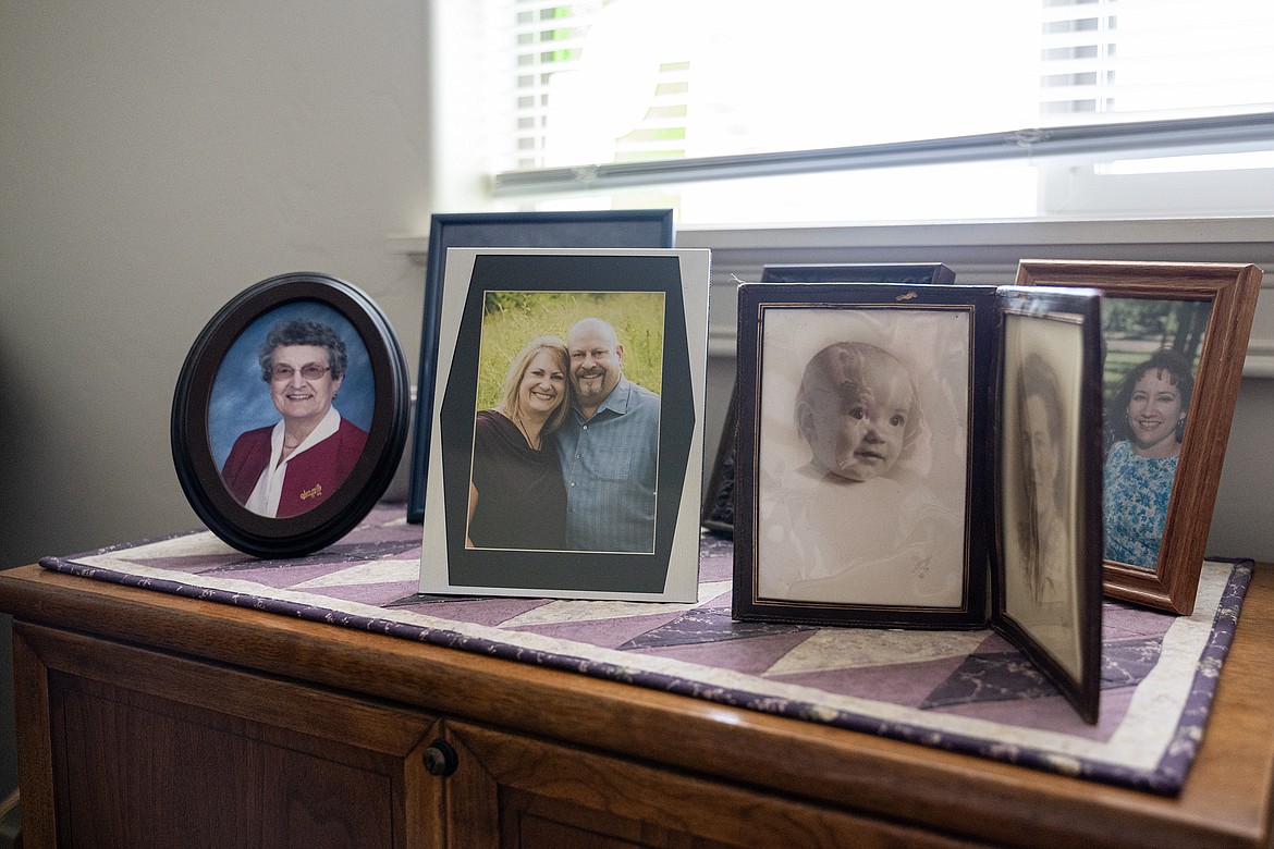 Leftover fabric from a quilting project serves as a runner for Barbara Taylor’s family photos.