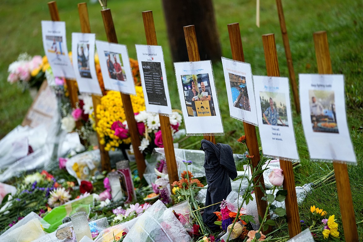 Rain soaked memorials for those who died in a mass shooting sit along the roadside by Schemengees Bar & Grille, Monday, Oct. 30, 2023, in Lewiston, Maine. Testimony stretched into a second day, Tuesday, April 9, 2024, as a legislative committee heard testimony on the red flag proposal that aims to let family members or others petition a judge to initiate the process of temporarily removing someone’s guns during a psychiatric crisis. (AP Photo/Matt York, File)