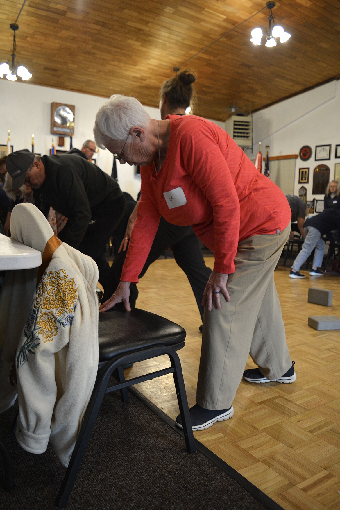 Pat Cook, of Coeur d'Alene strikes a yoga pose using a chair during a Coeur d'Alene Parkinson Support Group session.