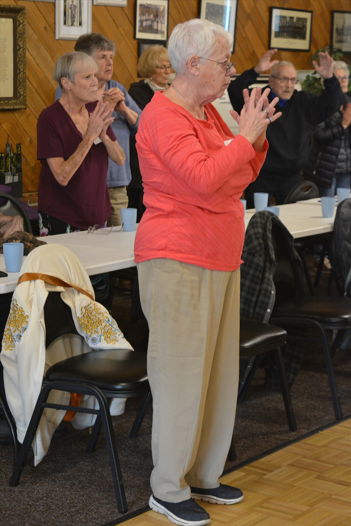 Pat Cook intertwines her fingers during a yoga session through the Coeur d'Alene Parkinson Support Group.