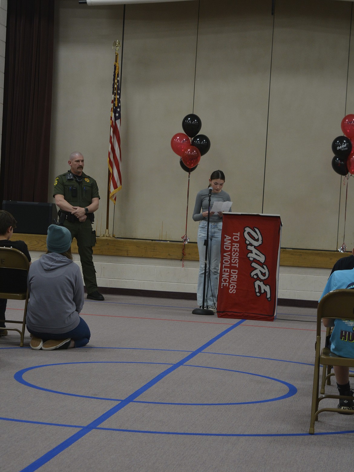 Zoey Darrah reads her speech aloud at the D.A.R.E. graduation assembly Friday at Garwood Elementary.