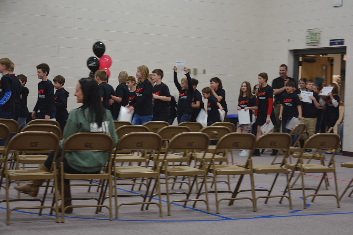 Fifth graders march back into the gym at Garwood Elementary after receiving t-shirts and certificates for completing the D.A.R.E. program.