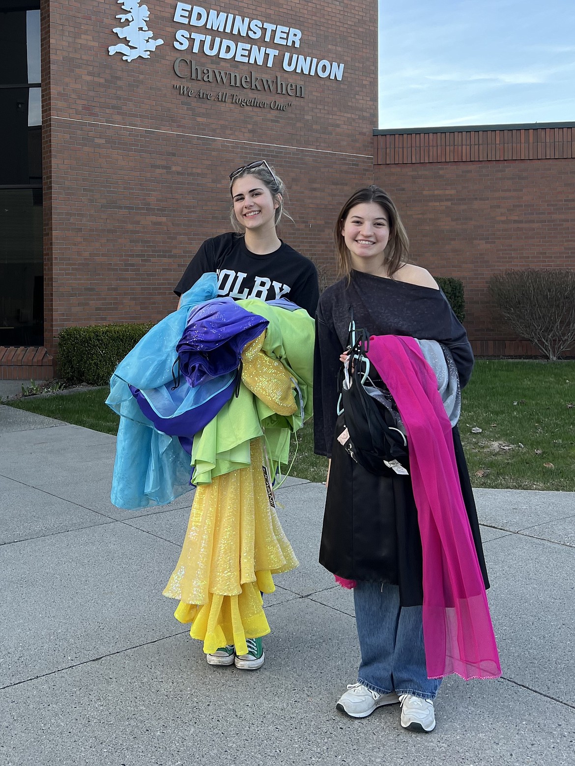 Club leaders Abby Fitzgerald and Ari Begalman of the Ant’oqmi’wes Club bring dresses to a pop-up dress drive at North Idaho College.