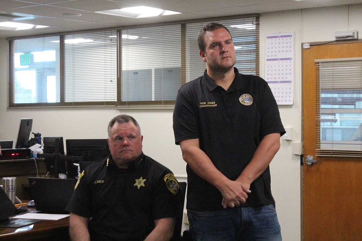 Grant County Sheriff Joey Kriete, left, and Grant County Commissioner Rob Jones, right, get a first look at the estimated costs of the new Grant County Jail Tuesday.