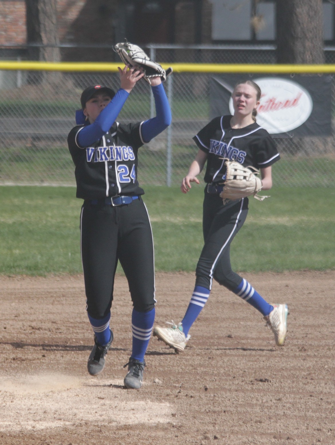 MARK NELKE/Press
Third baseman Abi Linder (24) of Coeur d'Alene snatches a popup as shortstop Molly Nelson (1) provides backup on Tuesday at Coeur d'Alene High.