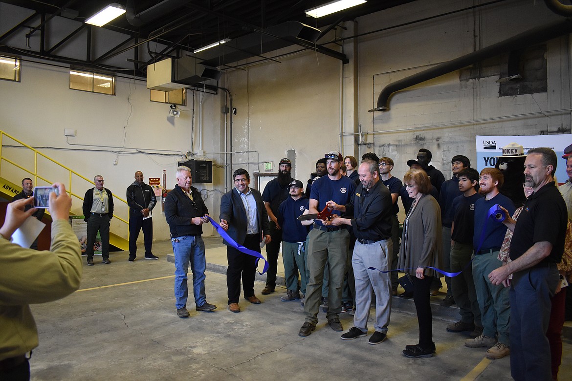 Columbia Basin Job Corps Center Fire Fighting Instructor Jacob Kovolitsky, left, and Center Director Mike Rios cut the ceremonial ribbon at the Job Corps Center’s new Advanced Fire Management training facility Wednesday, joined by state Sen. Judy Warnick, Job Corps personnel and students and members of the Moses Lake Chamber of Commerce.