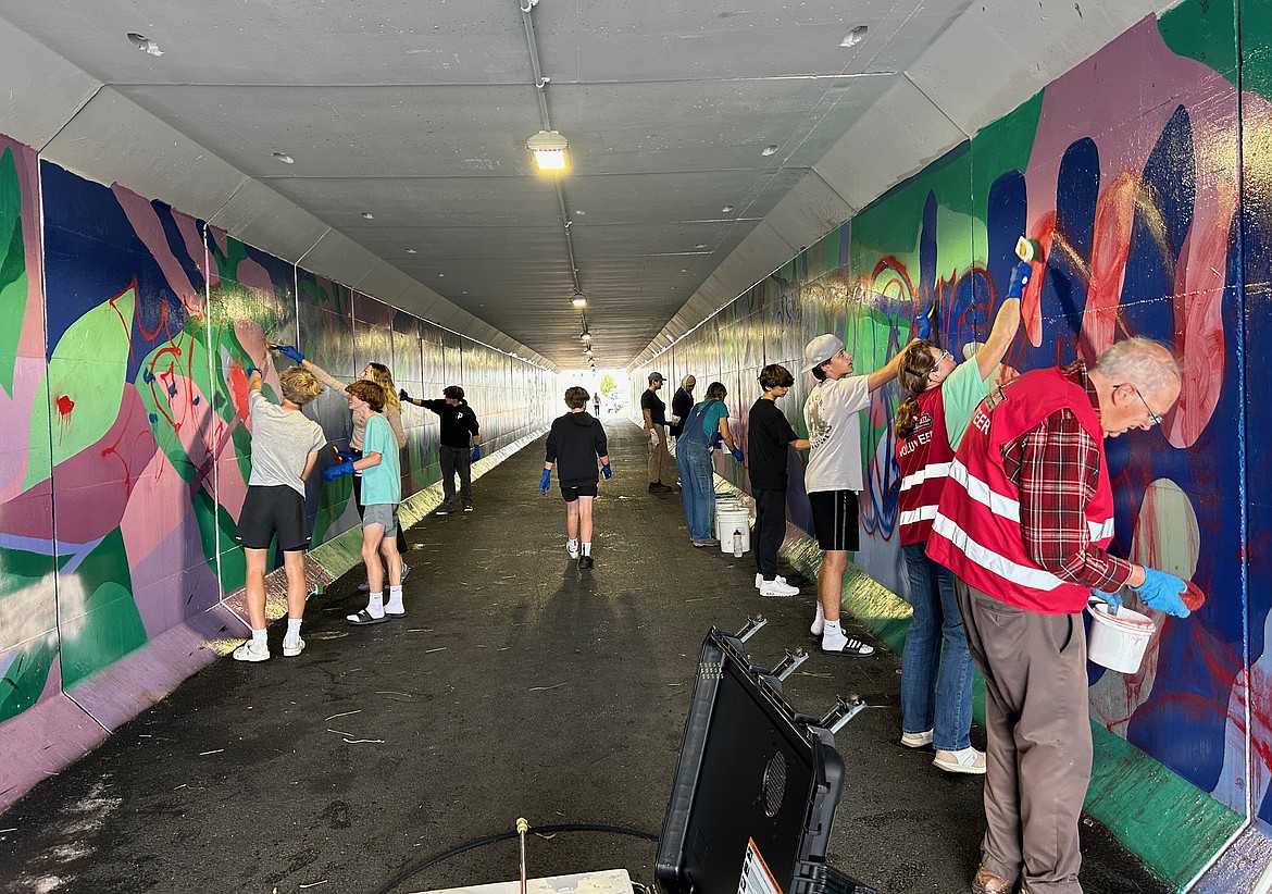 CRYJ teens work alongside community volunteers to clean up graffiti in a pedestrian tunnel in Kalispell. (Photo provided by CRYJ)