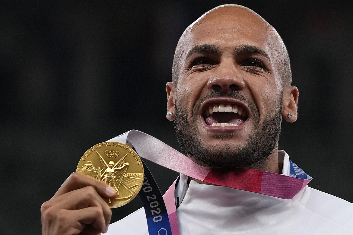 Lamont Marcell Jacobs, of Italy poses with his gold medal following the men's 100-meters final at the 2020 Summer Olympics, Monday, Aug. 2, 2021, in Tokyo. Track and field is set to become the first sport to introduce prize money at the Olympics, with World Athletics saying Wednesday, April 10, 2024, it would pay $50,000 to gold medalists in Paris. (AP Photo/Francisco Seco, File)