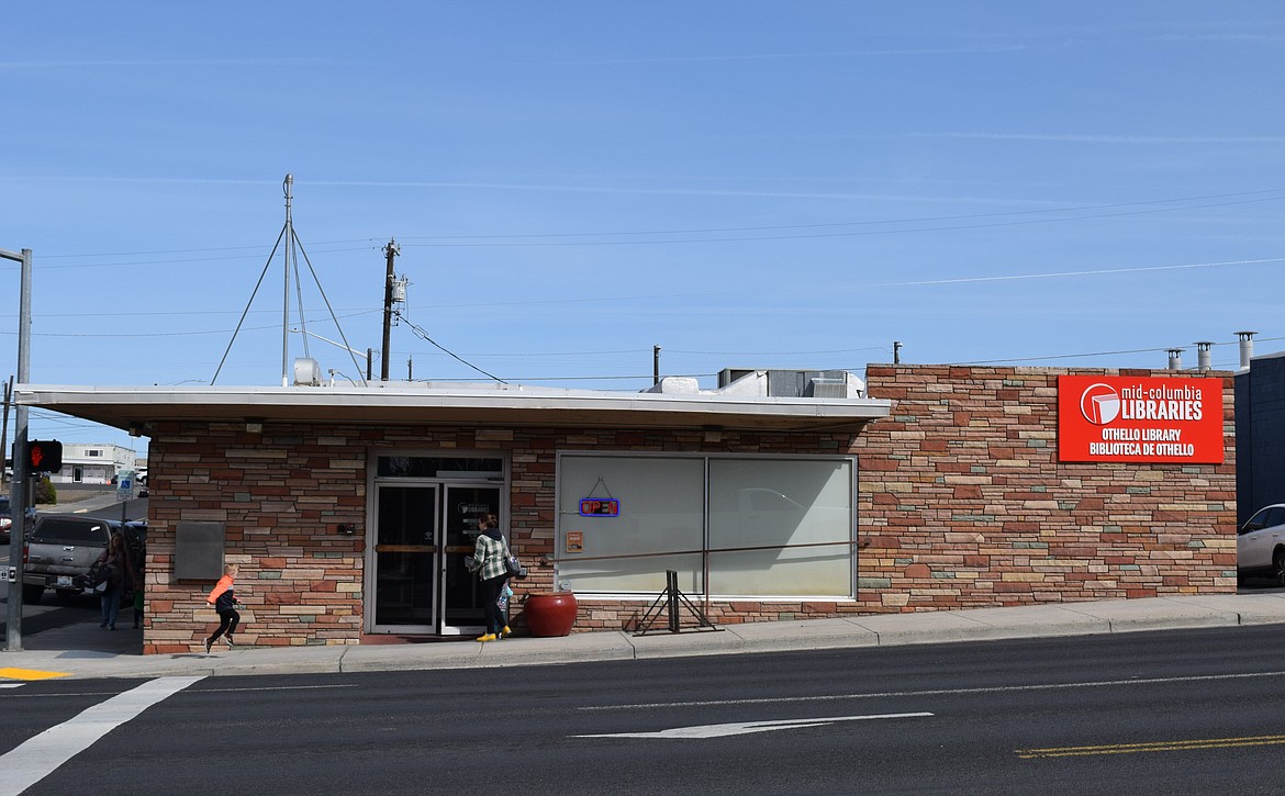 Patrons walk into the front entrance of the Othello Public Library, which sits at the bottom of the hill at the intersection of East Main Street and South First Avenue in downtown Othello. Mid-Columbia Libraries is evaluating the possibility of either remodeling the Othello branch or moving it to a new location.