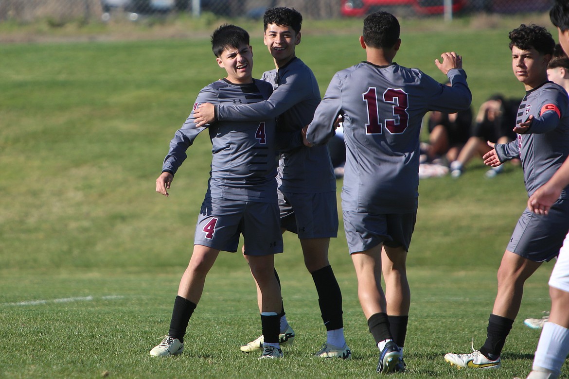 Wahluke teammates celebrate with junior Alvaro Rodriguez (4) after he scored a goal in the second half against College Place.