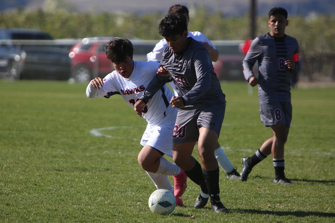 Wahluke senior Alessandro Maravilla (20) looks to steal the ball away from a College Place player on the attack.