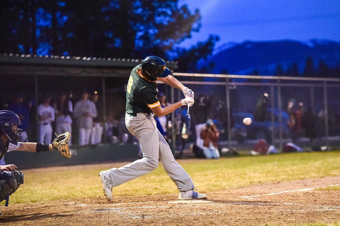 Whitefish's Tait Orme (9) drives in a run with an RBI single in the fifth inning against Columbia Falls at Sapa-Johnsrud Field on Thursday, April 11. (Casey Kreider/Daily Inter Lake)