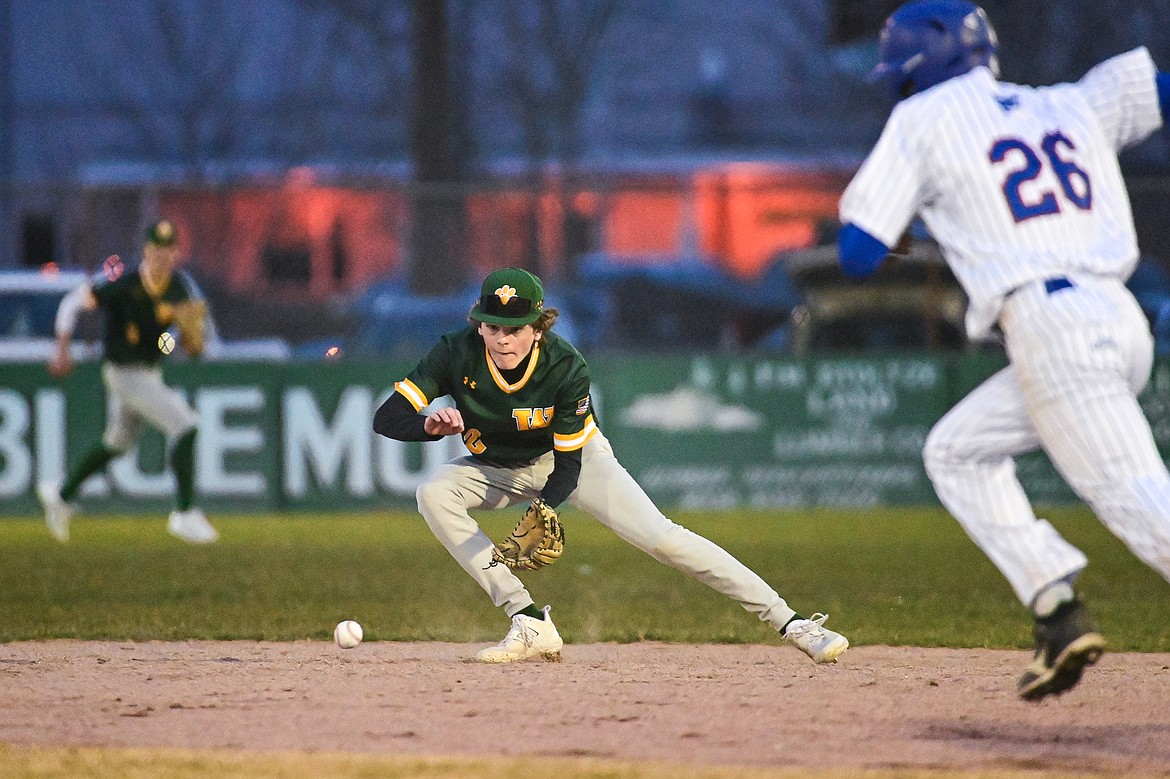 Whitefish second baseman Drew Queen (22) watches a ground ball into his glove against Columbia Falls at Sapa-Johnsrud Field on Thursday, April 11. (Casey Kreider/Daily Inter Lake)