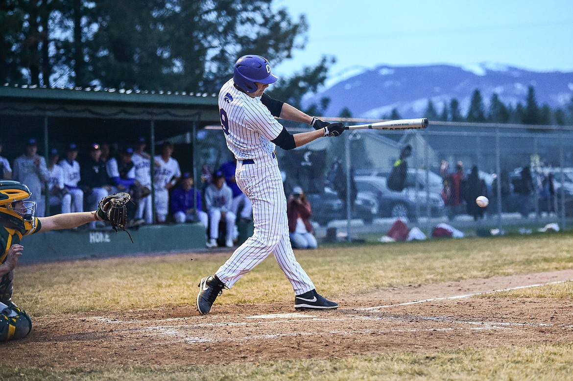 Columbia Falls Cody Schweikert (9) drives in a run with an RBI single in the third inning against Whitefish at Sapa-Johnsrud Field on Thursday, April 11. (Casey Kreider/Daily Inter Lake)