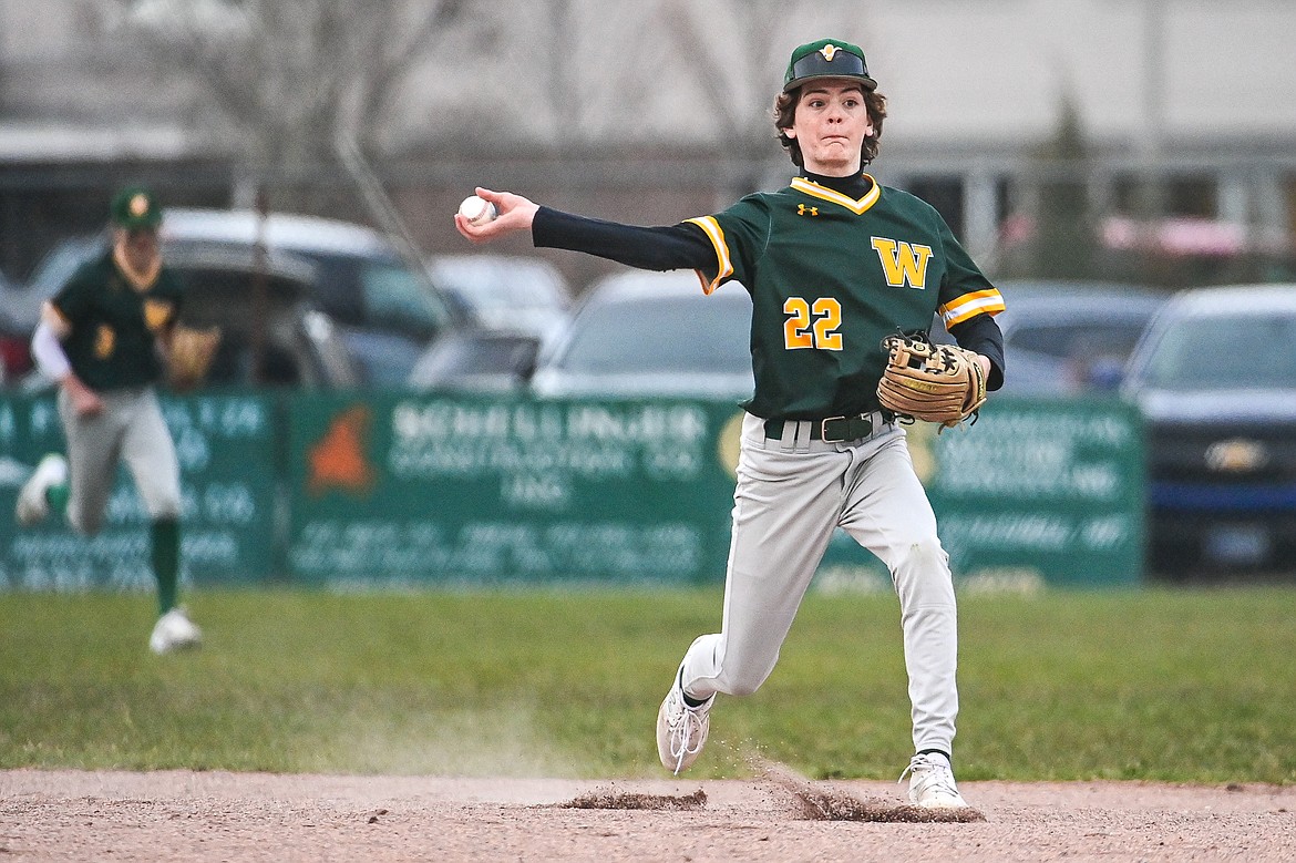 Whitefish second baseman Drew Queen (22) throws to first for an out against Columbia Falls at Sapa-Johnsrud Field on Thursday, April 11. (Casey Kreider/Daily Inter Lake)