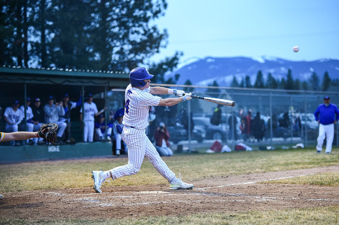Columbia Falls' Nico Young (4) drives in a run with a sacrifice fly against Whitefish at Sapa-Johnsrud Field on Thursday, April 11. (Casey Kreider/Daily Inter Lake)