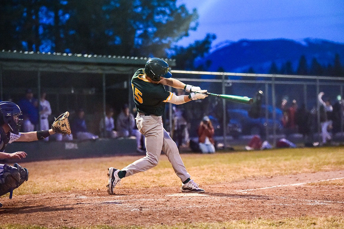Whitefish's CJ Thew (15) drives in a run with an RBI single in the fifth inning against Columbia Falls at Sapa-Johnsrud Field on Thursday, April 11. (Casey Kreider/Daily Inter Lake)